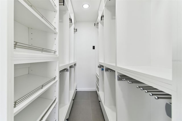 spacious closet with dark tile patterned floors