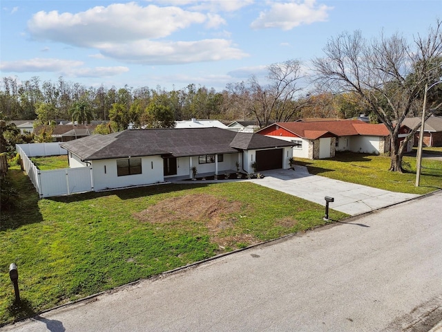 ranch-style house featuring a front yard and a garage