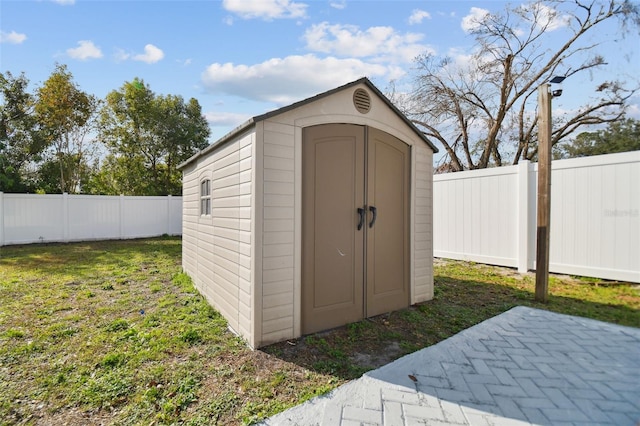 view of outbuilding featuring a lawn