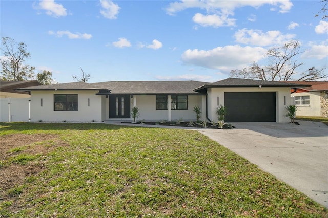 ranch-style house featuring a garage and a front lawn