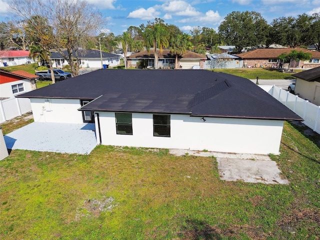 view of side of property featuring a yard and a patio area