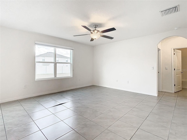 tiled spare room with ceiling fan