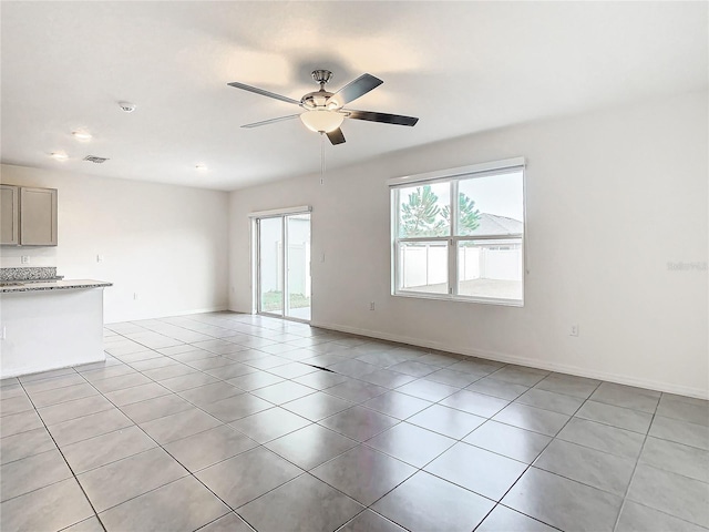 unfurnished living room with ceiling fan and light tile patterned flooring