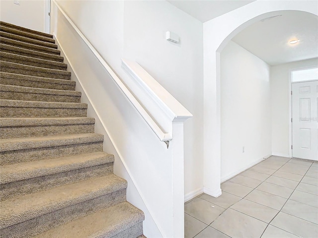 staircase featuring tile patterned floors