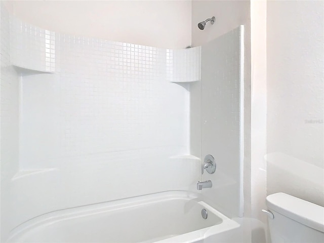 bathroom with toilet and tub / shower combination