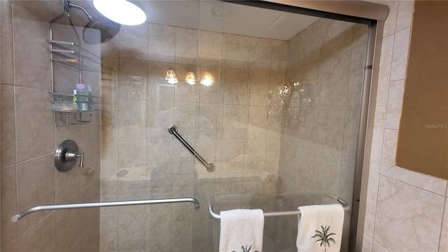 bathroom featuring a shower with shower door