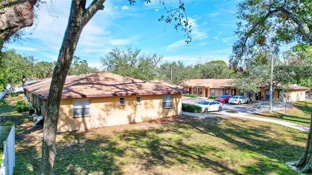 view of side of home with a lawn