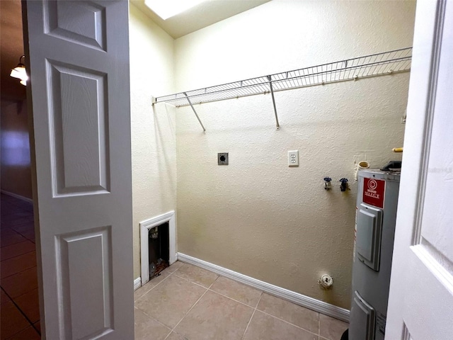 clothes washing area featuring light tile patterned floors, electric dryer hookup, and water heater