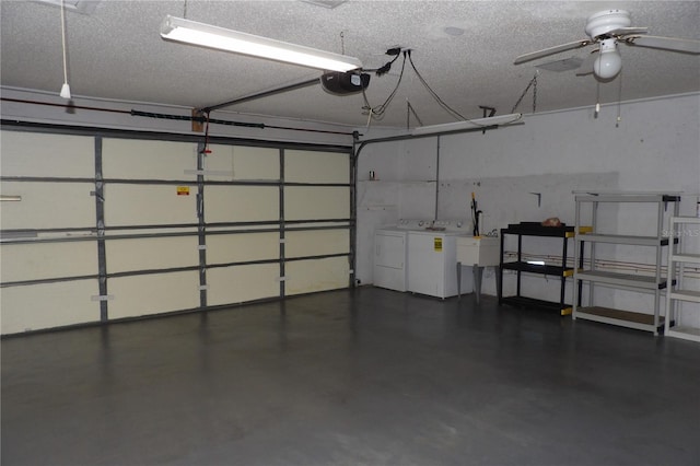 garage with a garage door opener, independent washer and dryer, and ceiling fan