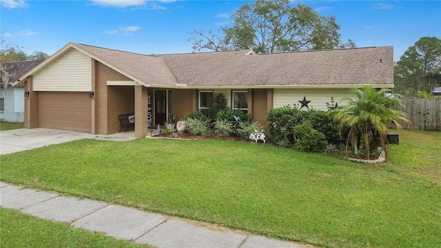 single story home with a garage and a front lawn