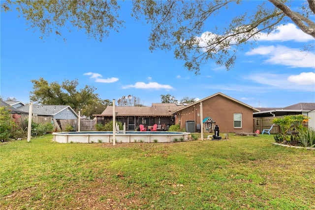 back of house featuring a yard and central air condition unit