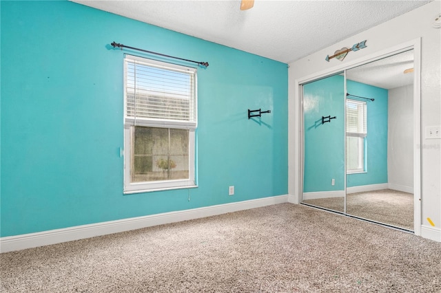 unfurnished bedroom featuring multiple windows, carpet floors, and a closet