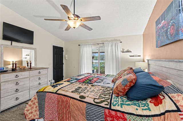 bedroom with ceiling fan, lofted ceiling, carpet flooring, and a textured ceiling