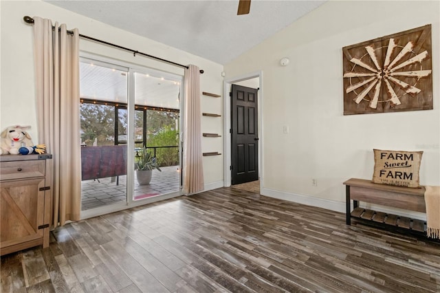 interior space with lofted ceiling, dark wood-type flooring, and a textured ceiling