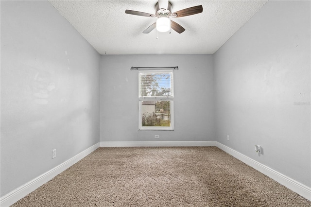 empty room with ceiling fan, carpet flooring, and a textured ceiling