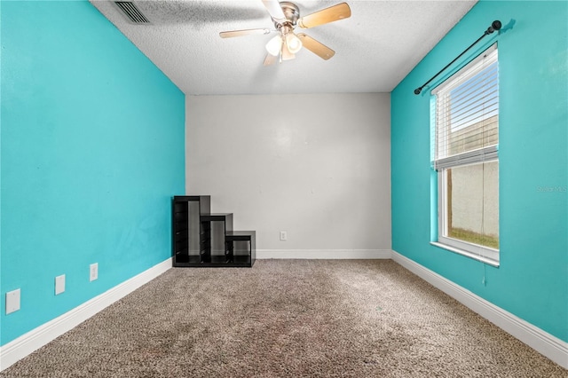 unfurnished living room featuring ceiling fan, carpet floors, and a textured ceiling