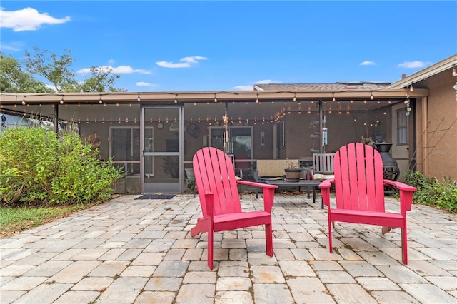 view of patio / terrace featuring a sunroom