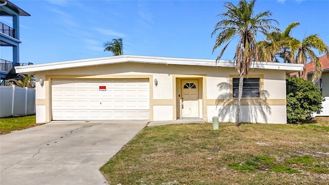 ranch-style home featuring a garage and a front lawn