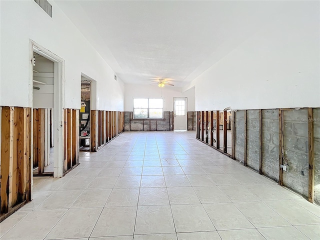 unfurnished room with ceiling fan and light tile patterned flooring