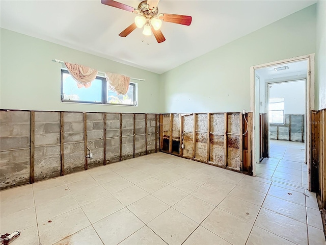 tiled spare room with ceiling fan