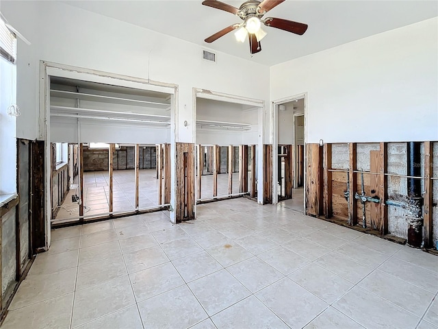 tiled empty room with ceiling fan