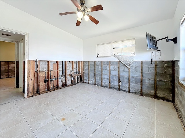 tiled spare room with ceiling fan