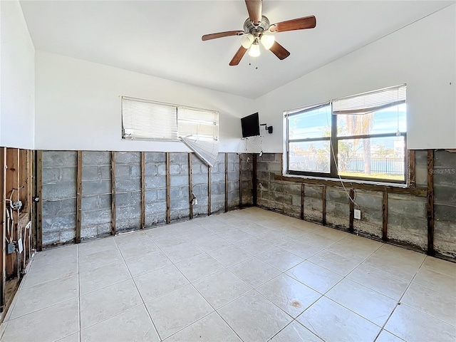 empty room with ceiling fan and light tile patterned flooring