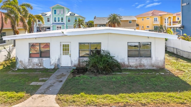 back of house with a lawn