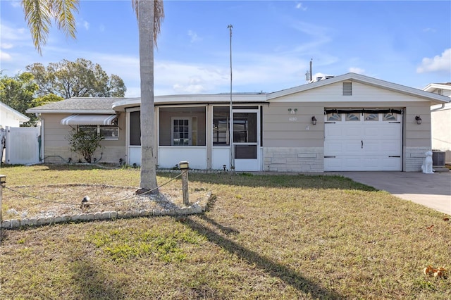 ranch-style home with a garage and a front lawn