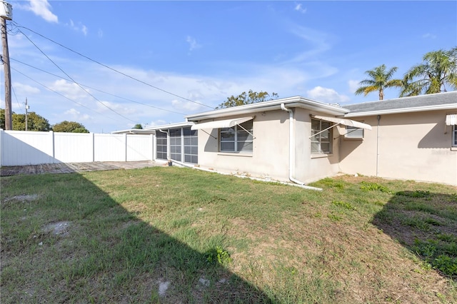 rear view of property with a yard