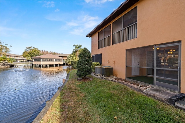 exterior space featuring a water view and central AC unit