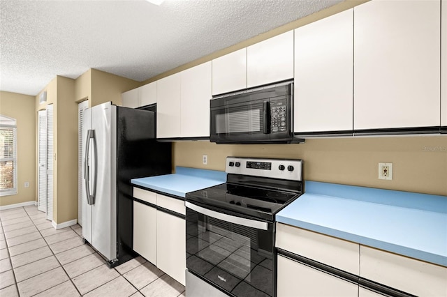 kitchen with white cabinets, a textured ceiling, stainless steel appliances, and light tile patterned flooring