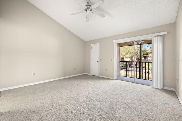 carpeted spare room featuring ceiling fan and vaulted ceiling