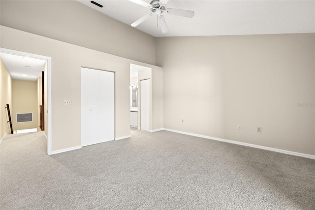 unfurnished bedroom featuring ensuite bath, ceiling fan, and light carpet