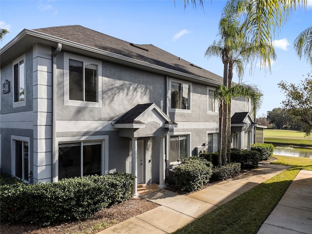 view of front of home with a water view