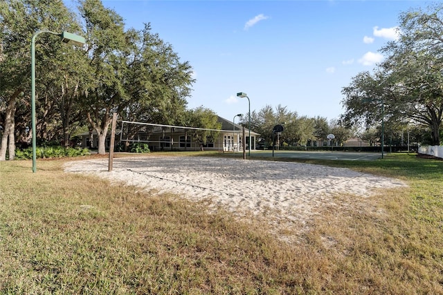 view of property's community featuring a lawn and volleyball court