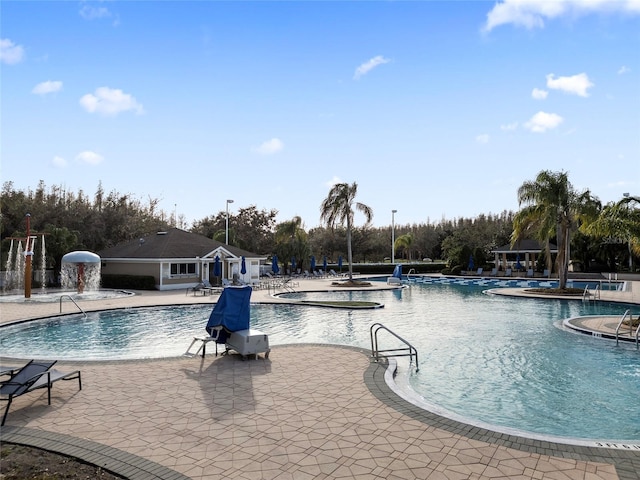 view of pool with pool water feature and a patio area