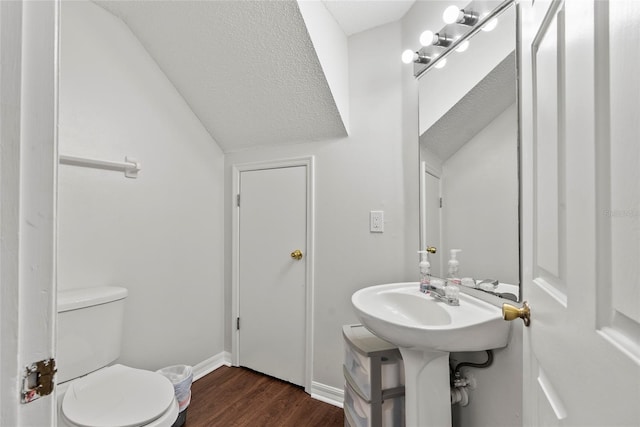 bathroom with wood-type flooring, toilet, and sink