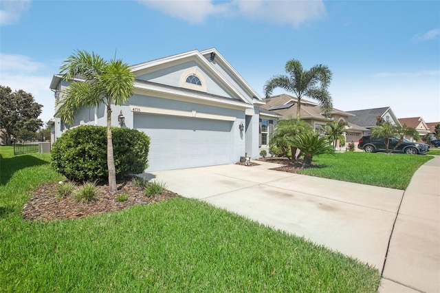 view of front of house with a front yard and a garage