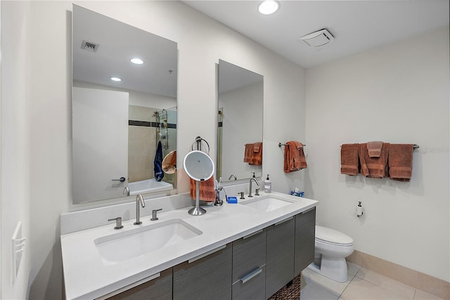 full bathroom with tile patterned floors, vanity, toilet, and tiled shower / bath combo