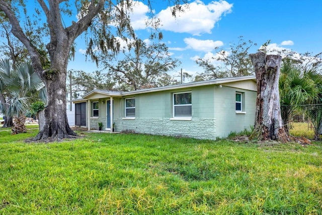 ranch-style home featuring a front yard