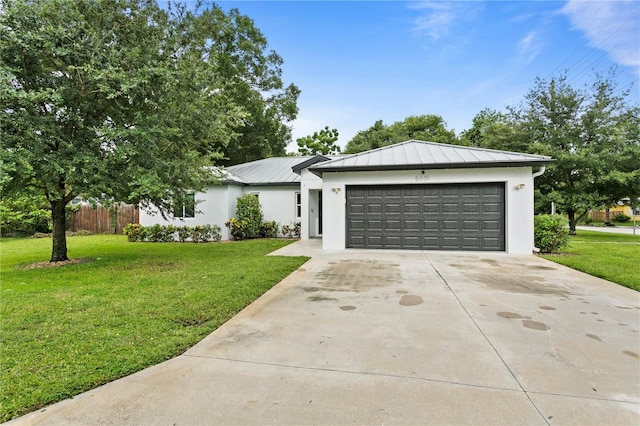 view of front of property featuring a garage and a front yard