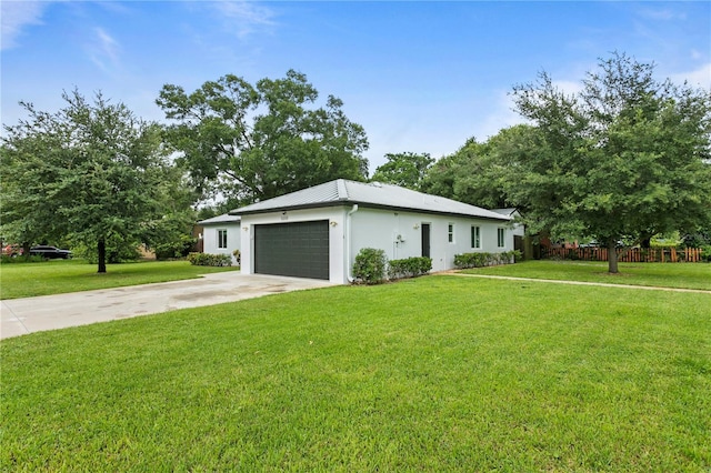 ranch-style home featuring a front lawn and a garage