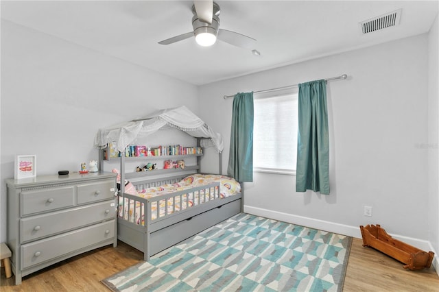 bedroom with ceiling fan and light hardwood / wood-style floors