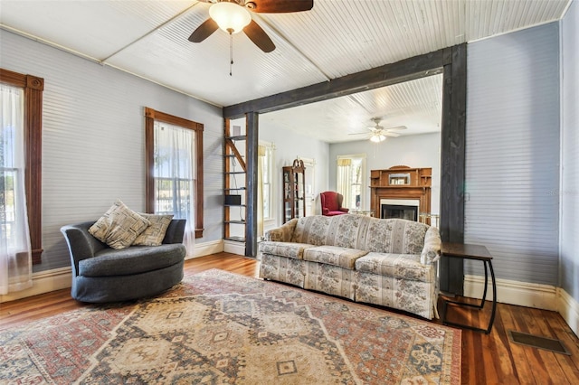 living room with hardwood / wood-style flooring, ceiling fan, and a healthy amount of sunlight