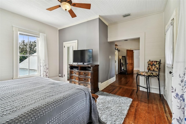 bedroom featuring ornamental molding, ceiling fan, and dark wood-type flooring