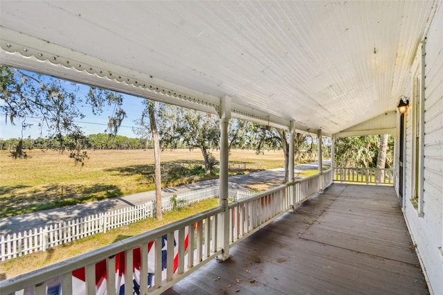 wooden terrace with a porch and a rural view