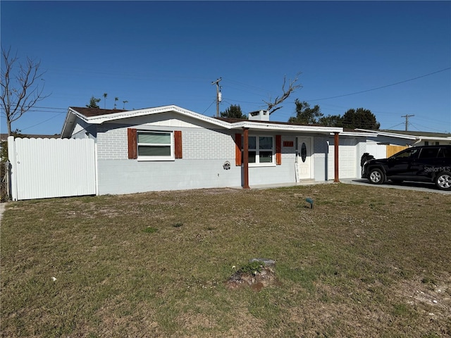 single story home with a carport and a front lawn