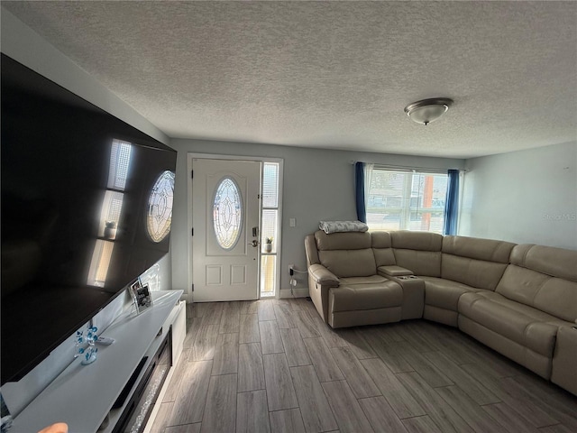 living room featuring a healthy amount of sunlight and a textured ceiling