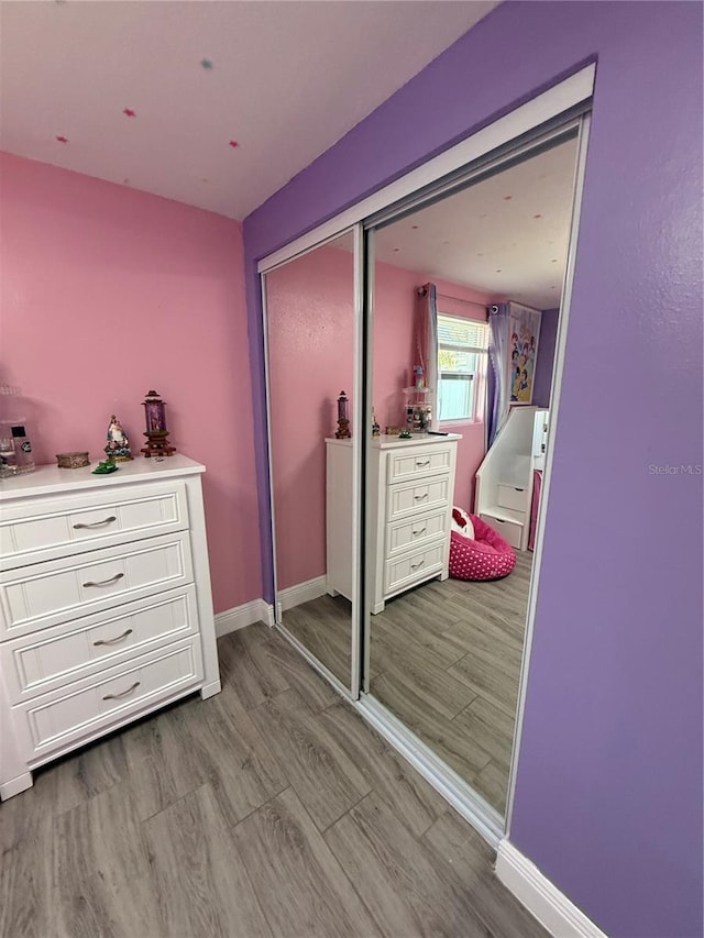 bedroom with a closet and light hardwood / wood-style flooring